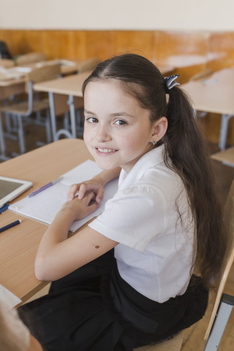 schoolgirl-with-ponytails-looking-camera